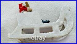 Vintage Santa Claus Sitting in Sleigh. 5.5 inches l, 4.5 inches h, 2 w