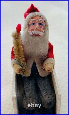 Vintage Santa Claus Sitting in Sleigh. 5.5 inches l, 4.5 inches h, 2 w